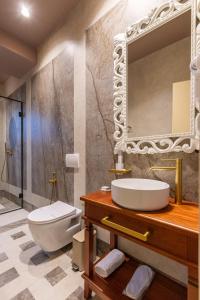a bathroom with a sink and a mirror at Vatër Hotel in Shkodër +168 photos