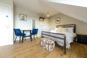 a bedroom with a bed and a table and chairs at The Willow Apartments in Bristol