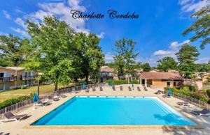a swimming pool with lounge chairs and a resort at Appartement T3 Barbaste in Barbaste