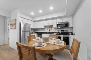a kitchen with a wooden table with chairs and a dining room at RC403A- The Landing Lookout condo in Branson