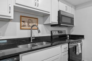 a kitchen with a sink and a microwave at RC403A- The Landing Lookout condo in Branson +32 photos