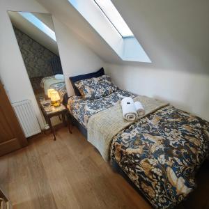 a bedroom with a bed with a pillow and a window at Outlander Boutique B&B ONLY ADULT Suite in Cruden Bay