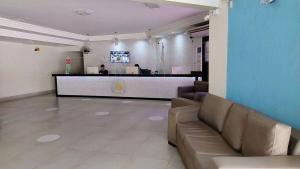 a lobby with a reception desk and a person in a office at CRCN - Aquarius Flat in Caldas Novas +37 photos