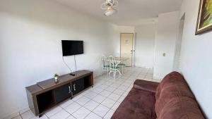 a living room with a couch and a flat screen tv at CRCN - Aquarius Flat in Caldas Novas