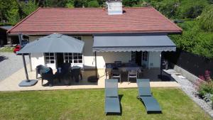 a house with an umbrella and a table and chairs at Angel Services - LA MAISON DE LA PLAGE in Sévrier +14 photos