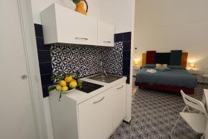 a kitchen with a sink and a bed in a room at Maison Gadì in Maiori
