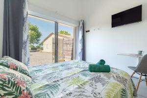 a bedroom with a couch and a large window at Chambres D'hotes Le Cocon De Lily in Saint-Avit +25 photos