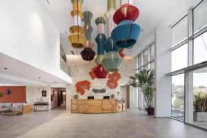 a lobby with colorful lights hanging from the ceiling at Barceló Praia Cape Verde in Praia