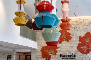 a group of colorful lights hanging from a wall at Barceló Praia Cape Verde in Praia +54 photos