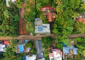 an overhead view of a city with houses and trees at De Waves Varkala by VOYE HOMES - Just 1 Km from Varkala Cliff and Beach in Varkala