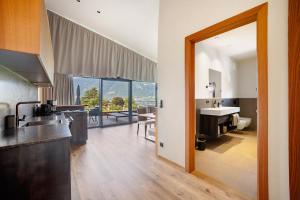 a large kitchen with a sink and a bathroom at Apartment Oberhaslerhof in Schenna