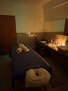 a hospital room with a bed and a sink at Lujan Homes Apart Hotel in Luján