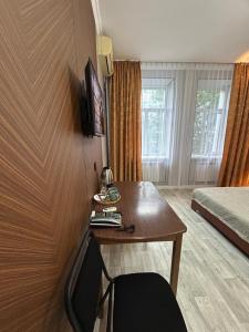 a hotel room with a desk and a bed at Жастар in Astana