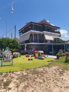 a large building with a playground in front of it at Paradisos in Loutsa