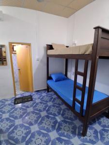 a room with two bunk beds and a doorway at Coral Moon in Trincomalee