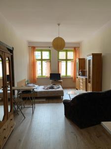 a living room with a bed and a table at Apartamenty w Kamienicy in Reszel
