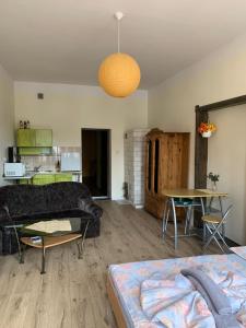 a living room with a couch and a table at Apartamenty w Kamienicy in Reszel