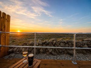 two glasses of wine on a deck with the sunset at Aran Islands Hotel in Kilronan +93 photos