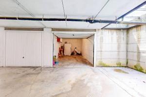 an empty room with a garage in a building at [BuenRetiro] Giardino, box e bici a disposizione in Acqui Terme