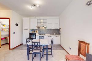a kitchen and dining room with a table and chairs at [BuenRetiro] Giardino, box e bici a disposizione in Acqui Terme +18 photos