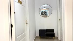 a hallway with a mirror and a black stool at B&B CORSO ROMA Room Suite & Spa in Apricena