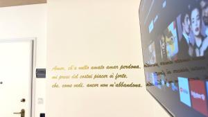a wall with a poster on the wall at B&B CORSO ROMA Room Suite & Spa in Apricena