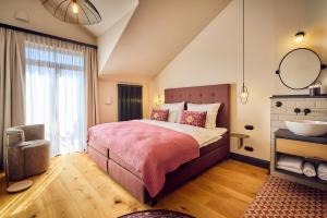 a bedroom with a bed and a sink and a mirror at Hotel Lahneck in Nievern