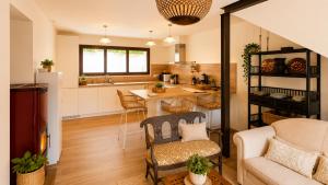 a kitchen and living room with a couch and a table at La Cuadra de San Pedro Ribadesella in Ribadesella +7 photos