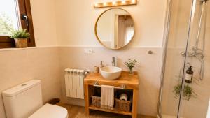 a bathroom with a sink and a mirror at La Cuadra de San Pedro Ribadesella in Ribadesella