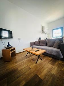 a living room with a couch and a coffee table at Apocalypsis Houses in Skala