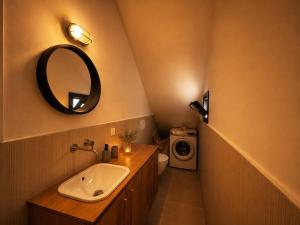 a bathroom with a sink and a mirror at ELÉNAS slow living villa in Faliraki +19 photos