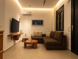 a living room with a couch and a table at ELÉNAS slow living villa in Faliraki