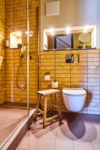 a bathroom with a toilet and a shower and a sink at Hotel Lahneck in Nievern
