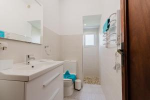 a white bathroom with a sink and a toilet at Holiday Home Kety in Portals Nous +16 photos