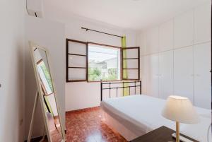a bedroom with a bed and a window at Holiday Home Kety in Portals Nous