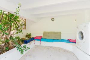 a living room with a couch and a washing machine at Holiday Home Kety in Portals Nous