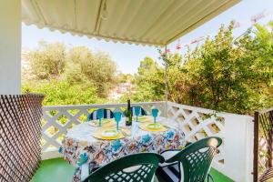 a table on a balcony with a table and chairs at Holiday Home Kety in Portals Nous