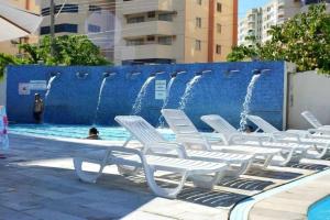a group of white chairs sitting next to a fountain at CRCN - Eldorado Thermas Park in Caldas Novas