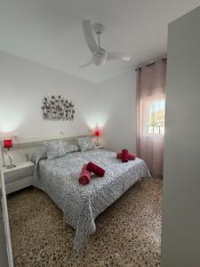 a bedroom with a bed with red slippers on it at Hospederia Ortiz 2 in Níjar
