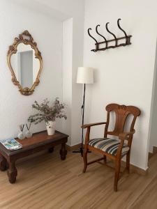 a room with a chair and a table and a mirror at Hospederia Ortiz 2 in Níjar
