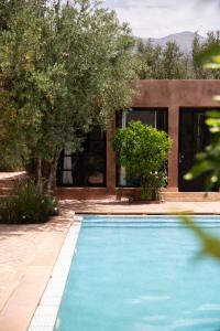 a swimming pool in front of a house at Villa Quince in Ouirgane