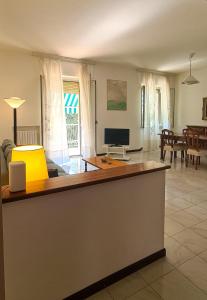 a kitchen and living room with a desk and a television at Miramare Apartment in Ancona