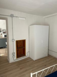a white room with a closet and a cabinet at Pola's House Biella Bio in Biella