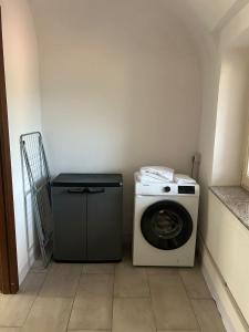 a washer and dryer in a small room at Pola's House Biella Bio in Biella +1 photo
