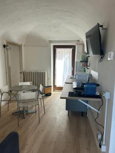 a room with a table and chairs in a room at Pola's House Biella Bio in Biella
