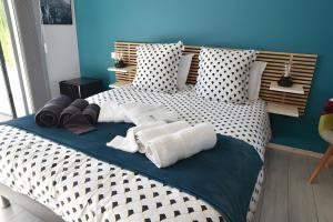 a bed with white and black pillows on it at Entre Mer Et Pinède Piscine in Bandol +20 photos