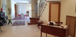 a large living room with a piano and a table at Appartamento "Sul Corso" Atessa in Atessa