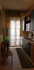 a kitchen with a sink and a table and a window at Appartamento "Sul Corso" Atessa in Atessa