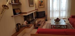 a living room with a couch and a fireplace at Appartamento "Sul Corso" Atessa in Atessa +11 photos