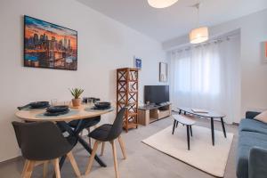 a living room with a table and chairs and a couch at Le Cocon de Cossé - Wifi - 300m Centre in Cossé-le-Vivien